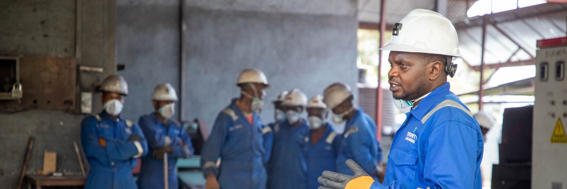 Training partners in high-visibility workwear reviewing compliance documentation on site
